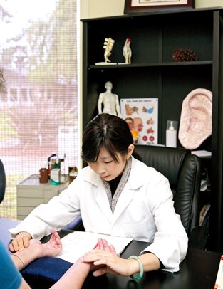 In her Sunnyvale office, Dr. Ching Ching Chi treats a stroke patient with acupuncture.