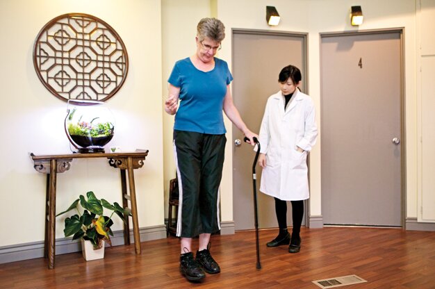 Dr. Ching Ching Chi works with patient Jean Craig, who suffered a stroke and brain hemorrhage two years ago.
