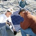 Job Train students Damien O’Brien and Maurice Williams work on the rooftop installation.