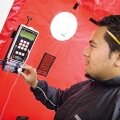Tony Sapiga of the Green Jobs Corps tests for unwanted air infiltration, which wastes energy.
